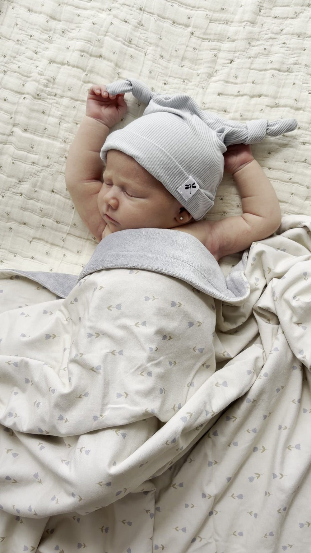 Baby sleeping in a Lilulila bamboo sleepsuit