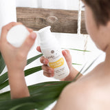 Child holding Carelia Botanical Bug Repellent natural mosquito lotion